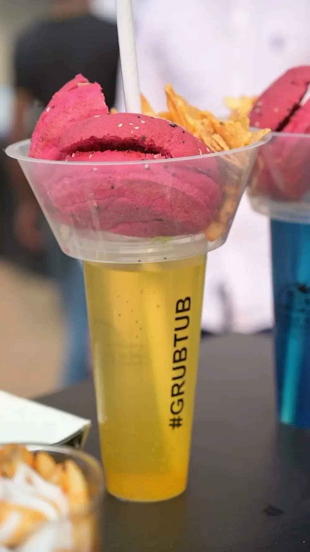 A cup of pink gelato with a wafer, and a glass marked #GRUBTUB